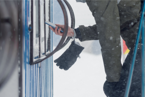 Skiier Using Self-Service Ticket Kiosk