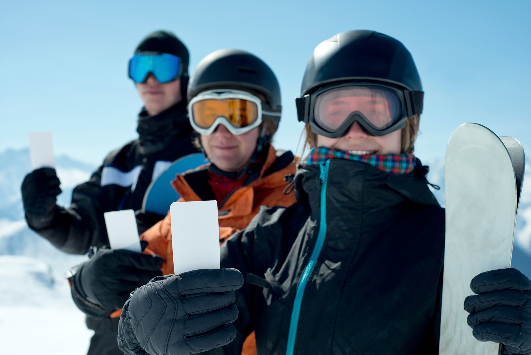 skiers holding Ikon Pass - Deer Valley